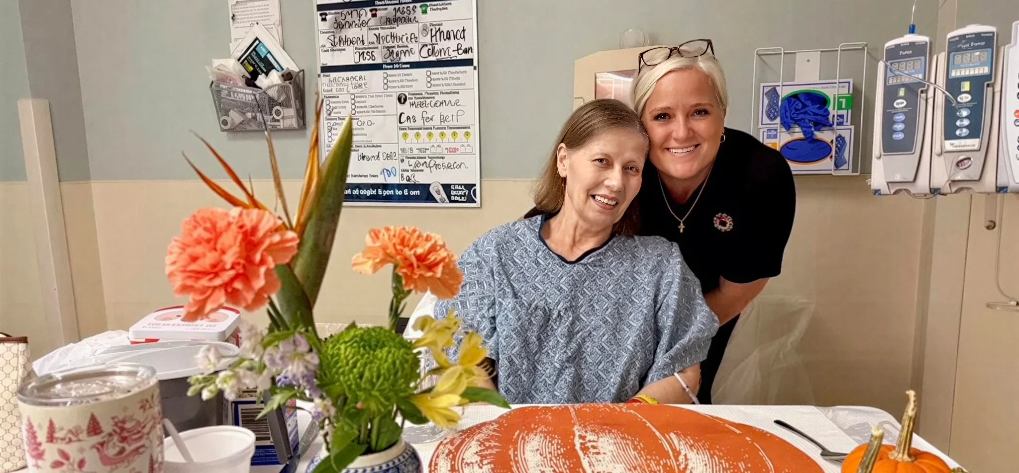 Hospital bedside with patient, visitor, autumn decorations