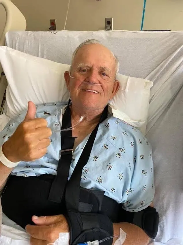 Elderly patient in hospital bed giving thumbs-up
