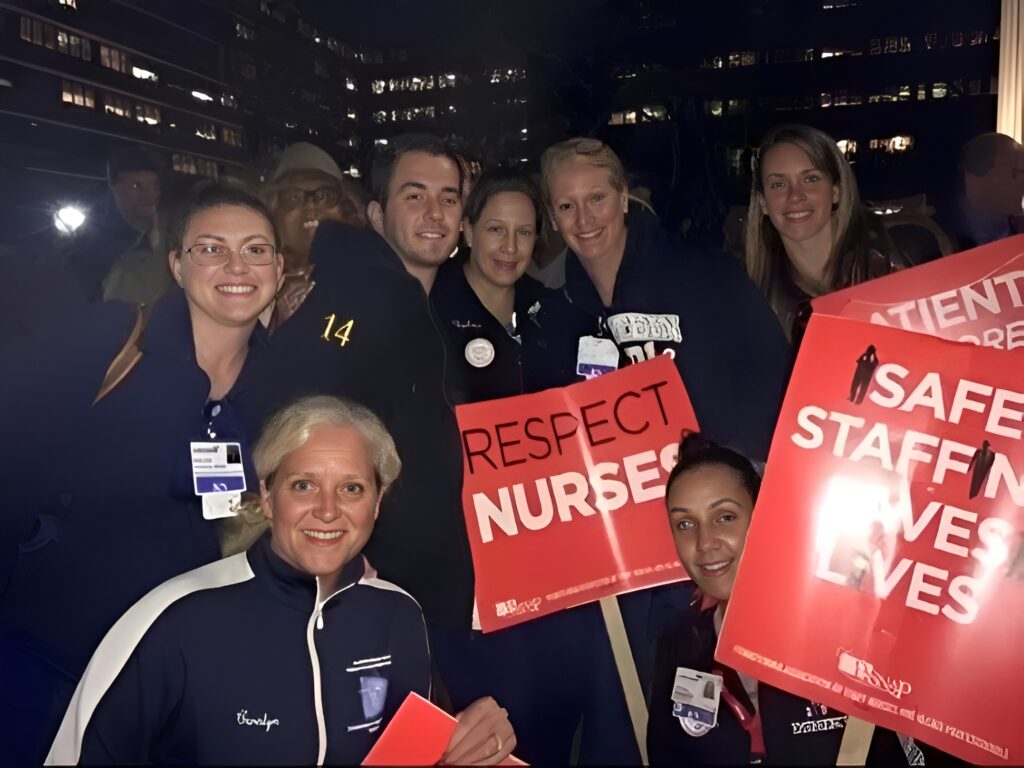 Group of nurses holding "Respect Nurses" signs