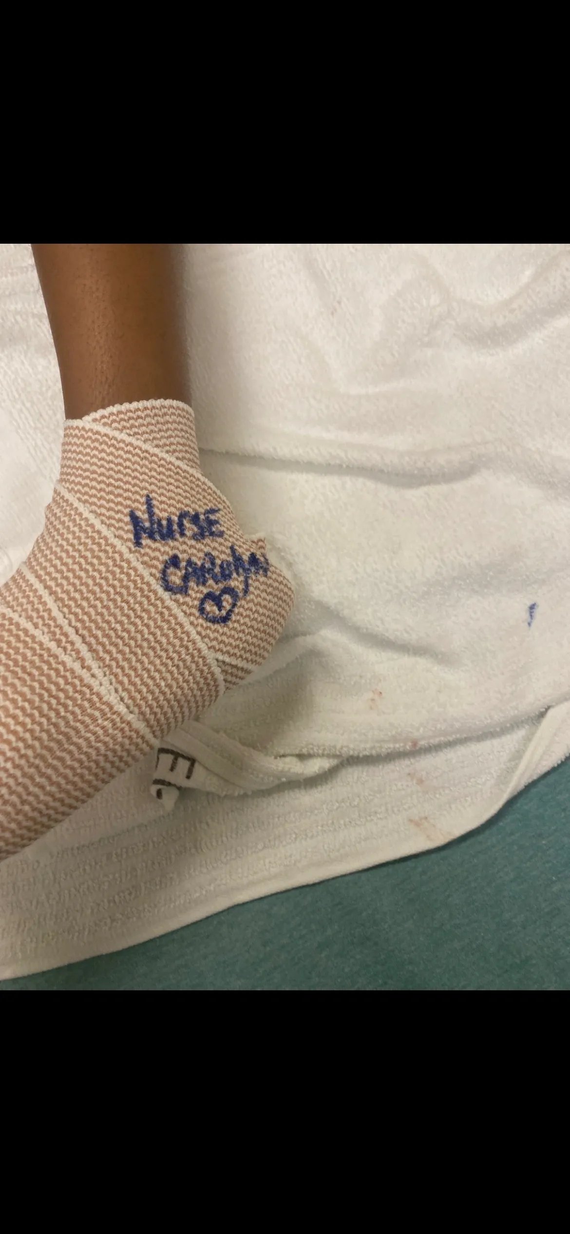 Bandaged heel with blue handwritten message