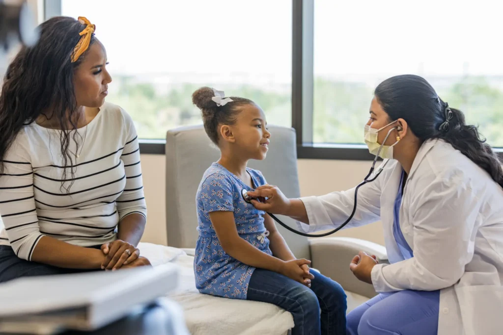 Young girl smiles during doctor visit.