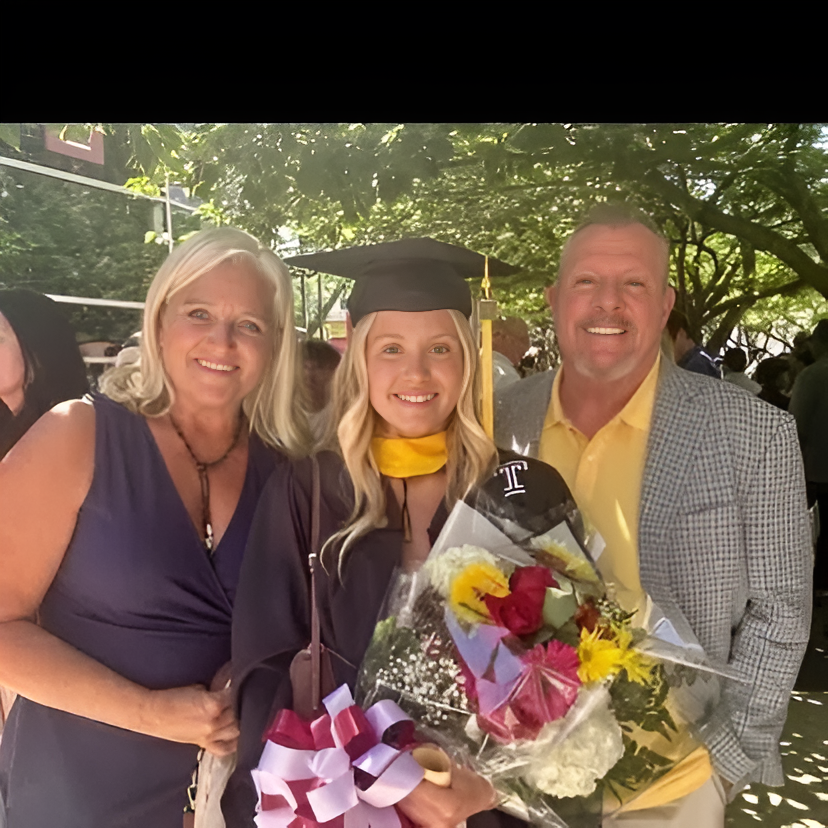Graduation celebration with family and flowers.