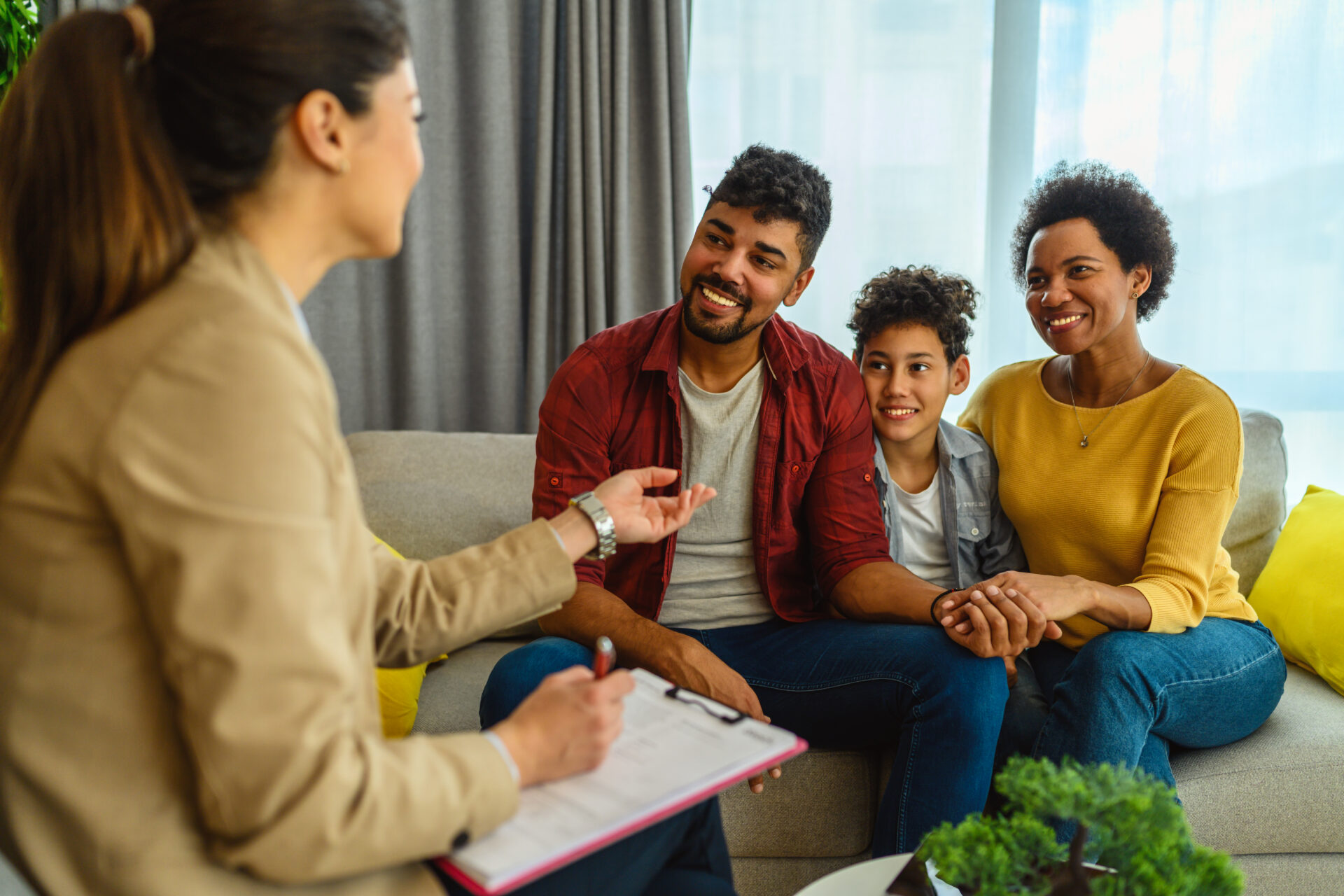 Family engaged in conversation with a counselor.