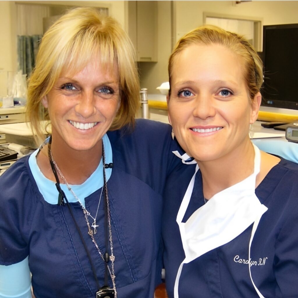 Two healthcare workers smiling together.