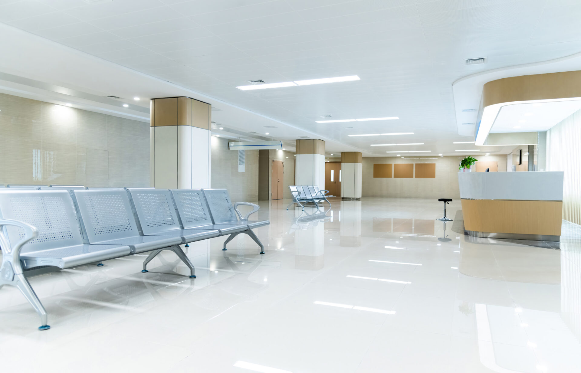 Modern hospital waiting area with empty seats.